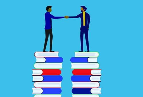 businessman holding a deal on a high pile of books
