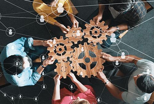 group of people connecting gears in a education exercise