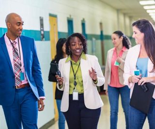 educators talking in a school hallway